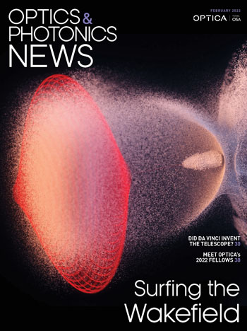 A laser pulse (red) in an ionized gas drives a bubble-shaped plasma wave of electrons (white) that an electron bunch rides like a surfer riding an ocean wave.