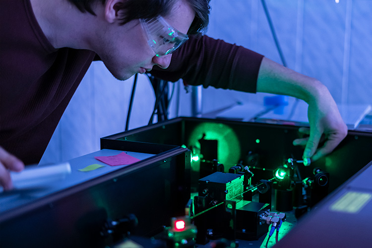 photo of researcher adjusting laser