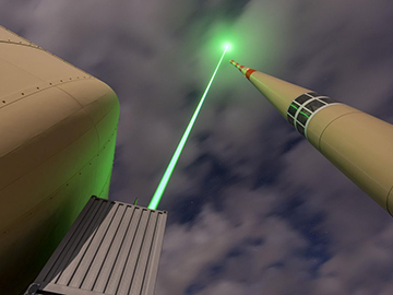 Laser firing into sky from facility