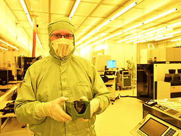 Man in cleanroom with wafer