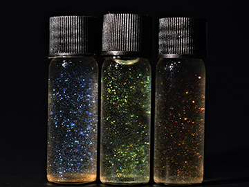 Photo of three vials containing nanocrystals of different colors