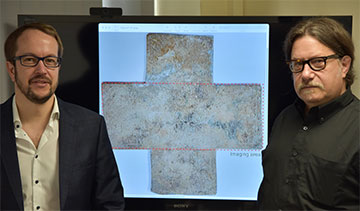 Researchers with funerary cross