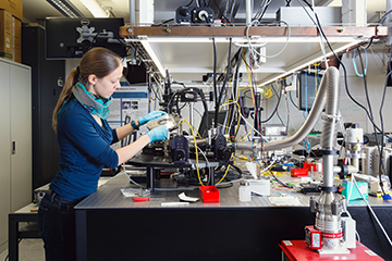 Photo of Claudia Hössbacher in a laser lab